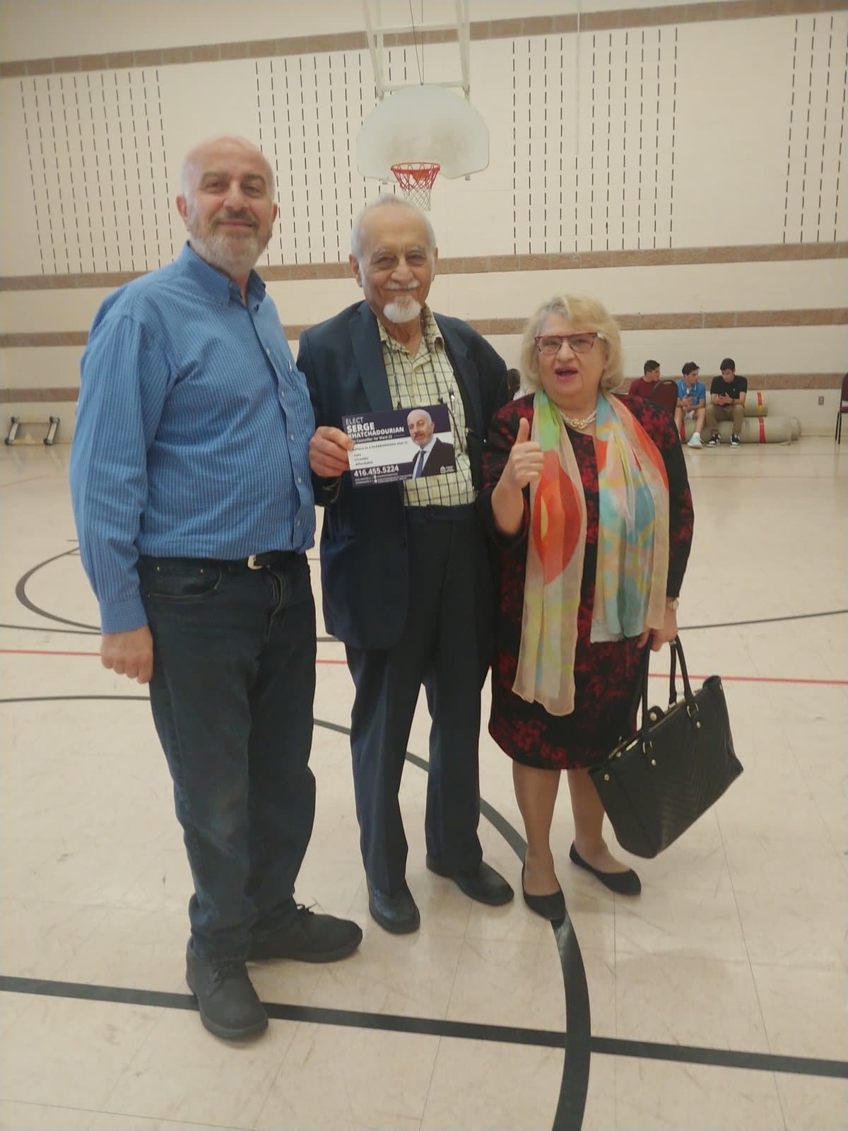 Serge Khatchadourian with community members at a school gymnasium event