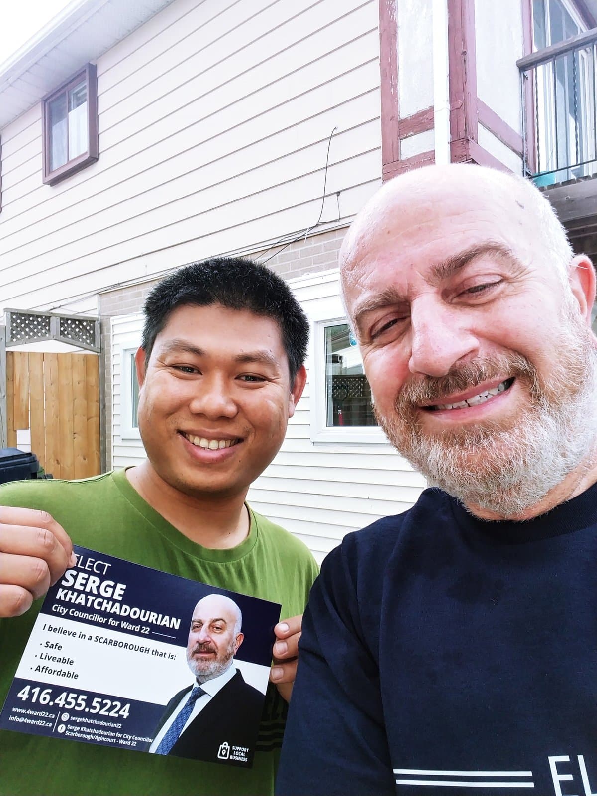 Serge Khatchadourian with a resident while canvassing door to door