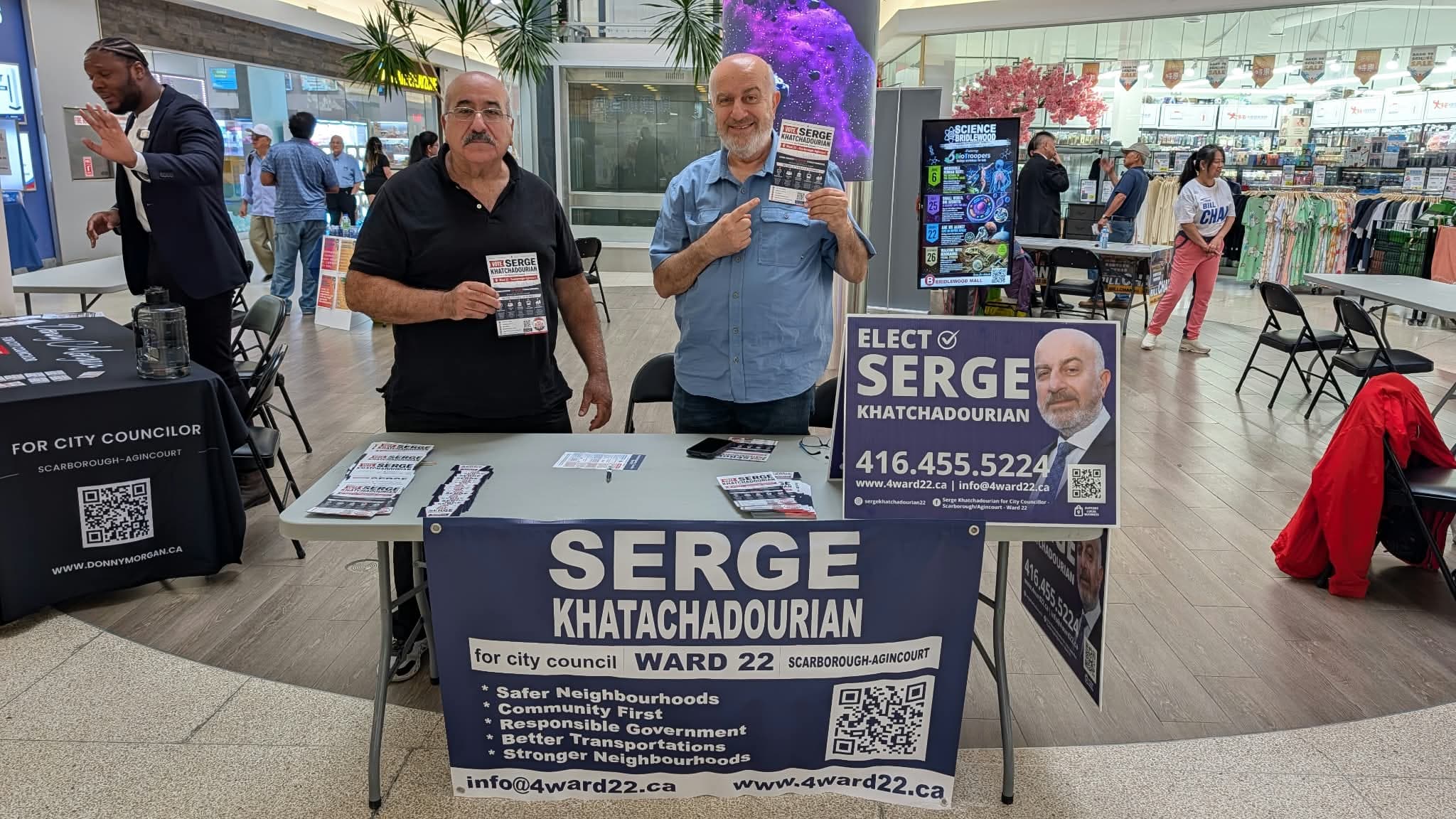 Serge Khatchadourian and a supporter at a campaign information table in Bridlewood Mall