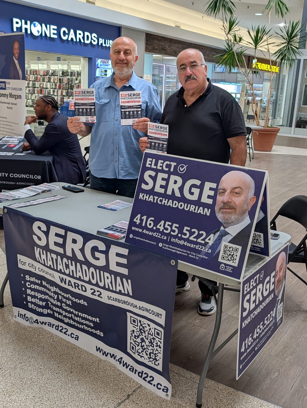 Serge Khatchadourian and a supporter holding campaign flyers at a Bridlewood Mall information table