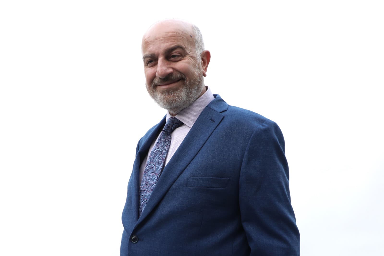 Serge Khatchadourian smiling in a blue suit